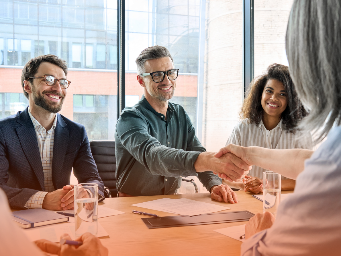 Professionals shaking hands in a conference room