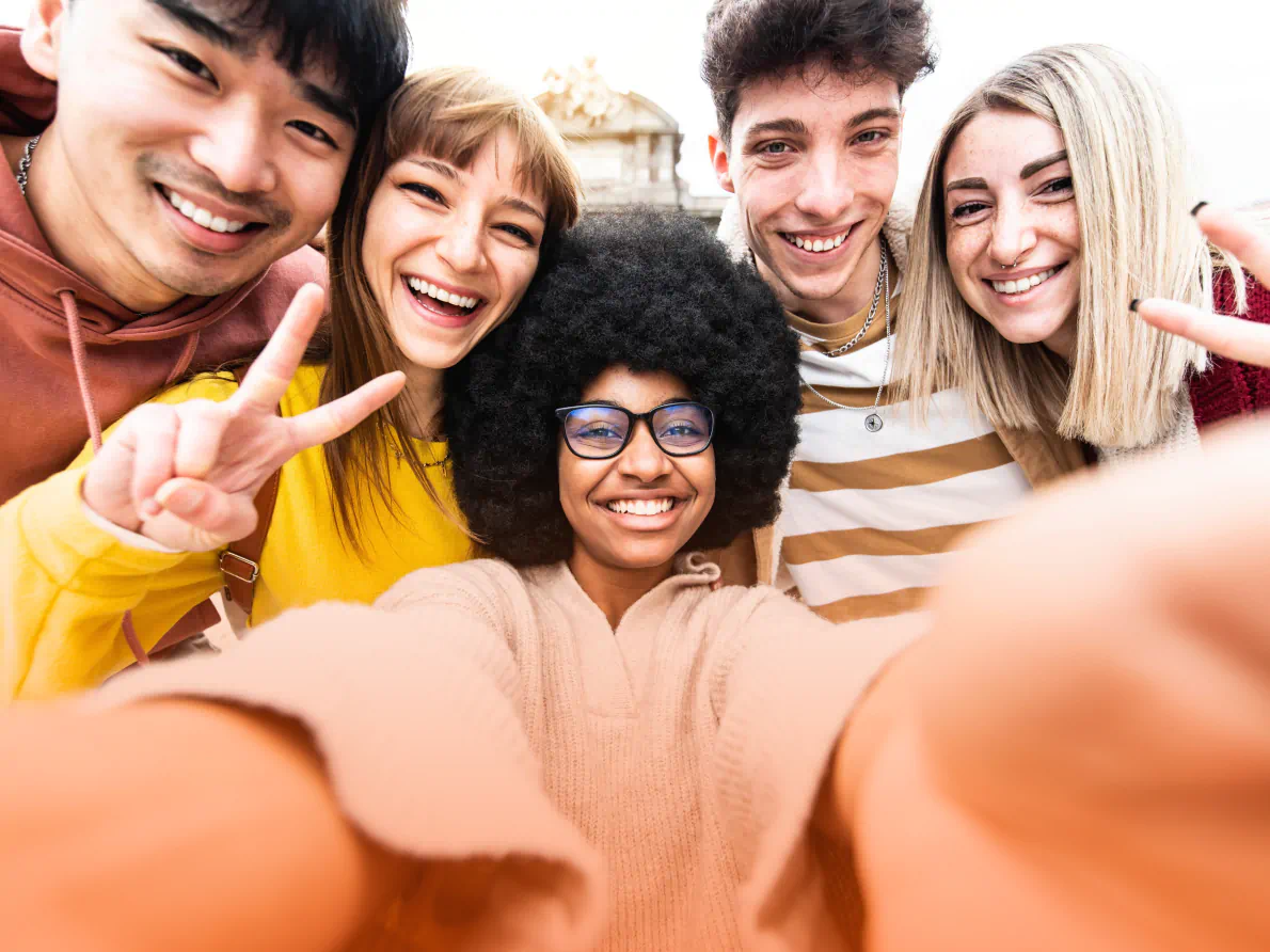 A diverse group of people laughing as they work together