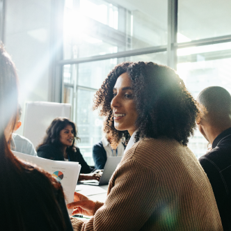 Coworkers sitting at conference table talking