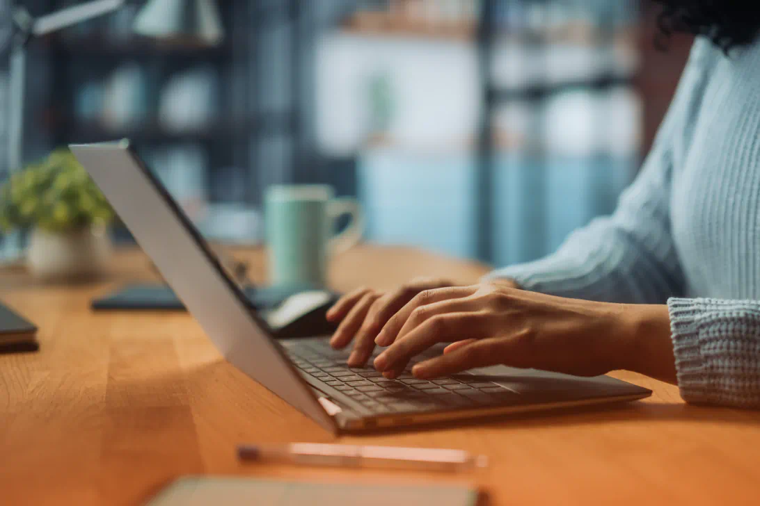 Hands on a laptop keyboard