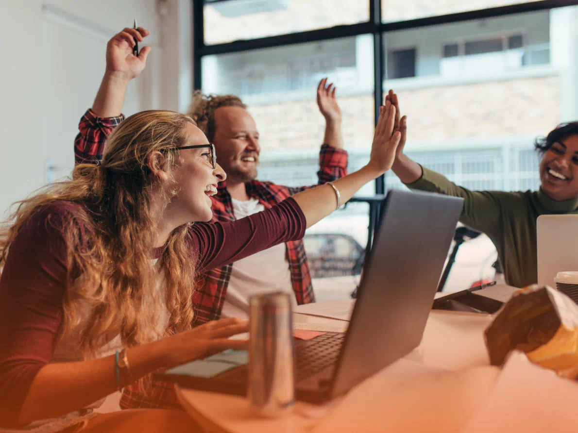 Coworkers celebrating in conference room