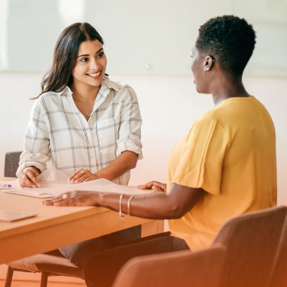 Two people talking at a table