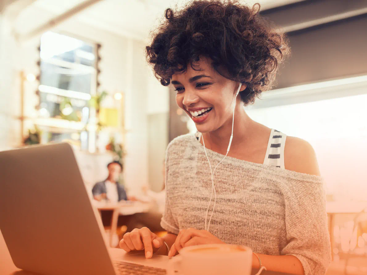 Woman smiling and using laptop computer