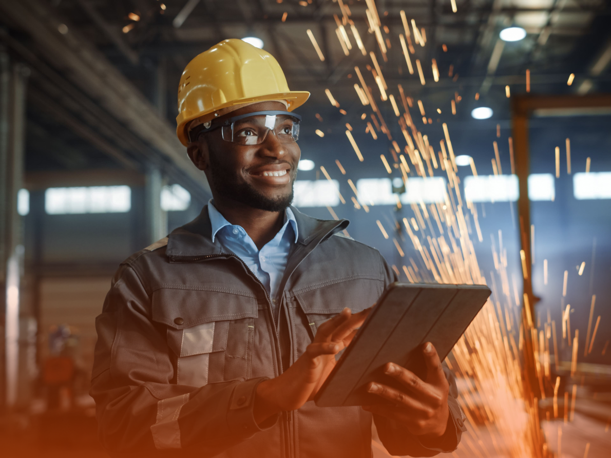 Man in hard hat holding tablet device